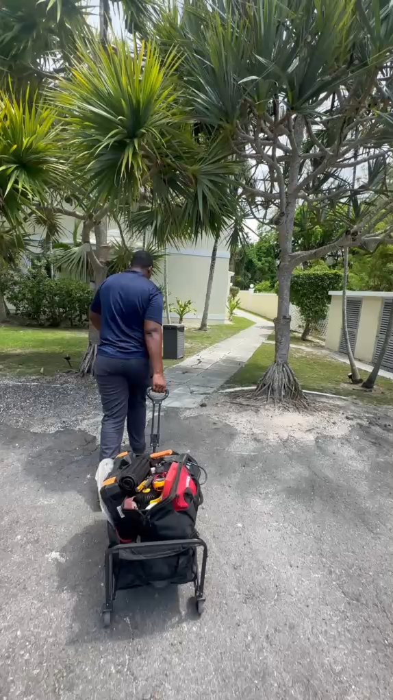 Cold Masters technician arriving at a home in Nassau with his tool cart